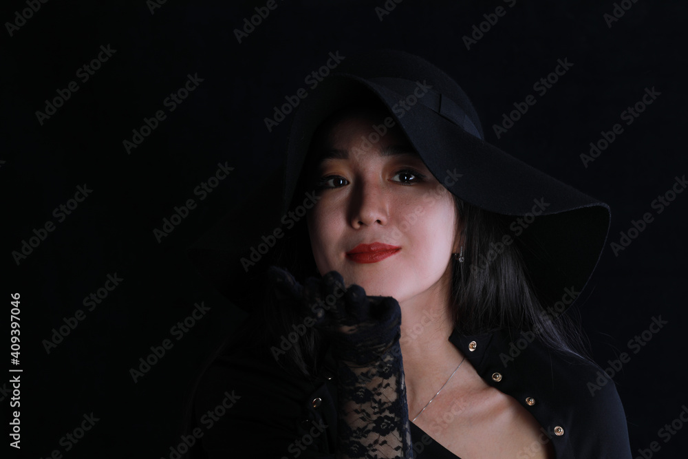 close-up studio portrait of a beautiful girl in a black hat on a black background close-up studio portrait of a beautiful girl in a black hat on a black background