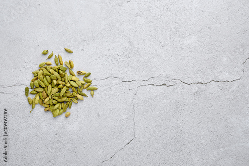 Pile of cardamom on abstract background.