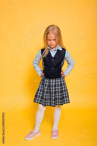 Wallpaper Mural Girl in school uniform posing isolated on yellow background. Torontodigital.ca