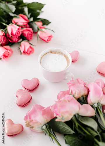 Coffee cup on a empty surface with a hheart-shapedmacaroon, pink vibes