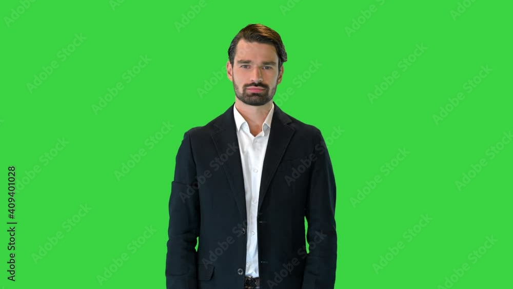Handsome man in a suit pushing virtual buttons presenting something on a Green Screen, Chroma Key. Handsome man in a suit pushing virtual buttons presenting something on a Green Screen, Chroma Key.