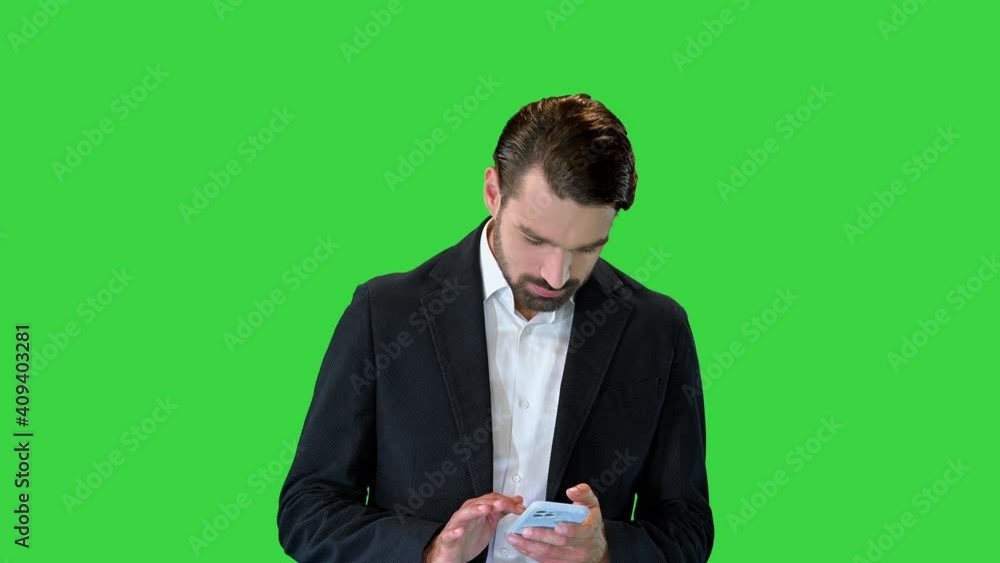 Celebrating success, business achievement, lottery win, looking at phone screen, reading great news in email or message on a Green Screen, Chroma Key. Celebrating success, business achievement, lottery win, looking at phone screen, reading great news in email or message on a Green Screen, Chroma Key.