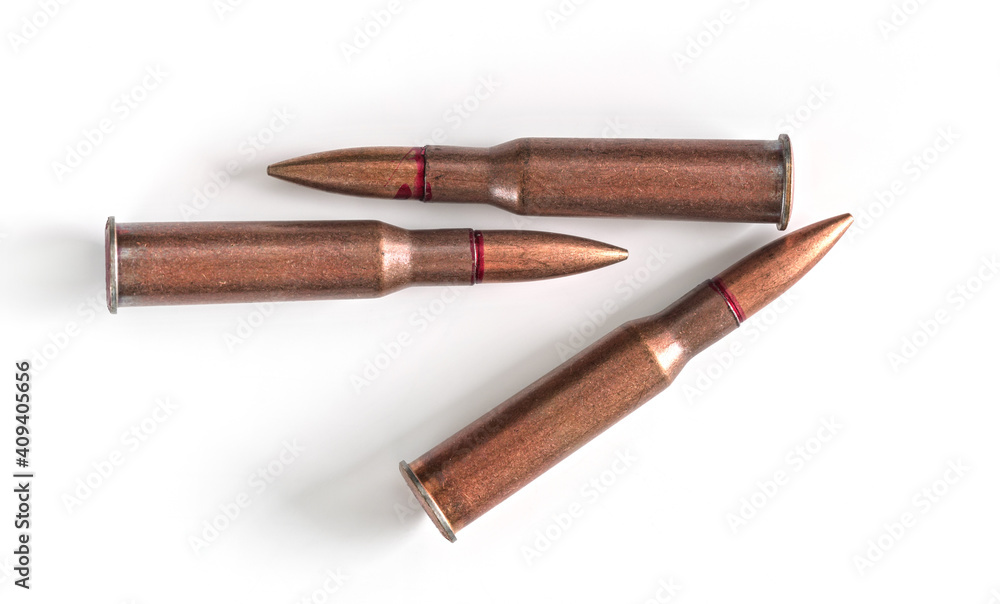Three copper machine gun bullets isolated on white background