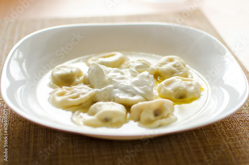 dumplings on a table with butter and sour cream. Close-up photo.