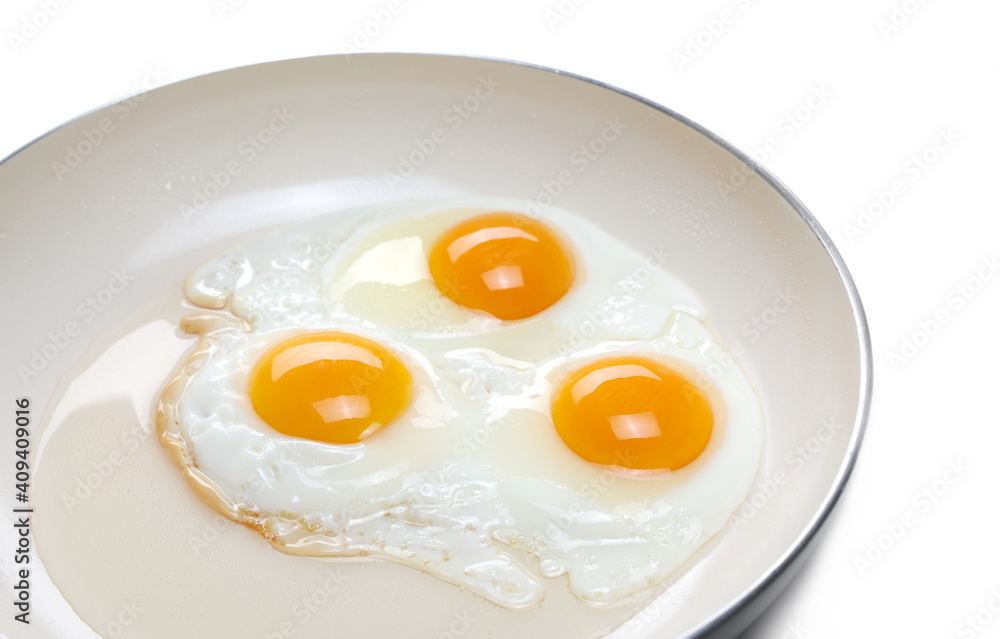 Fried eggs on frying pan isolated on white background Fried eggs on frying pan isolated on white background
