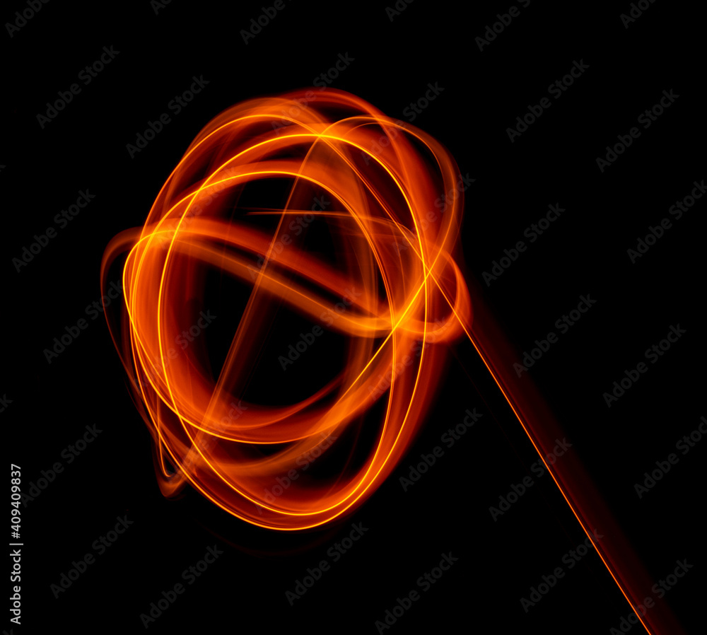 Light wave trail path, vibrant neon gold color in abstract swirls on a black background