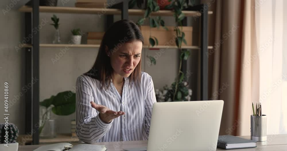 Unhappy young business lady looking at computer screen, feeling confused by failure. Frustrated millennial woman reading email with unpleasant news, stressed by mistake or having problem with device. Unhappy young business lady looking at computer screen, feeling confused by failure. Frustrated millennial woman reading email with unpleasant news, stressed by mistake or having problem with device.