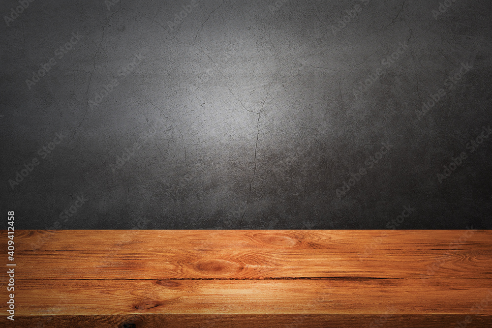 Wooden decking table on a grey grunge background. Wooden decking table on a grey grunge background.
