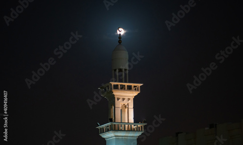 Obraz na plátně background image of mosque minaret during full moon night