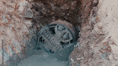 Close-up view of small tunnel boring machine on construction site. 