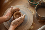 A woman makes a clay product. Close-up of hands