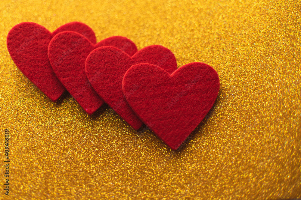 Red felt hearts on golden shiny background. Valentine's Day Red felt hearts on golden shiny background. Valentine's Day