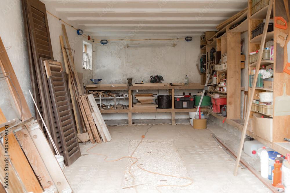 Various carpenter's tools and supplies in a garage. Various carpenter's tools and supplies in a garage.