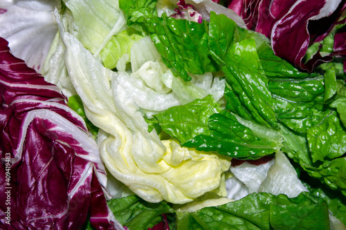 close-up of a fresh salad with iceberg lettuce and radicchio . selective focus photo