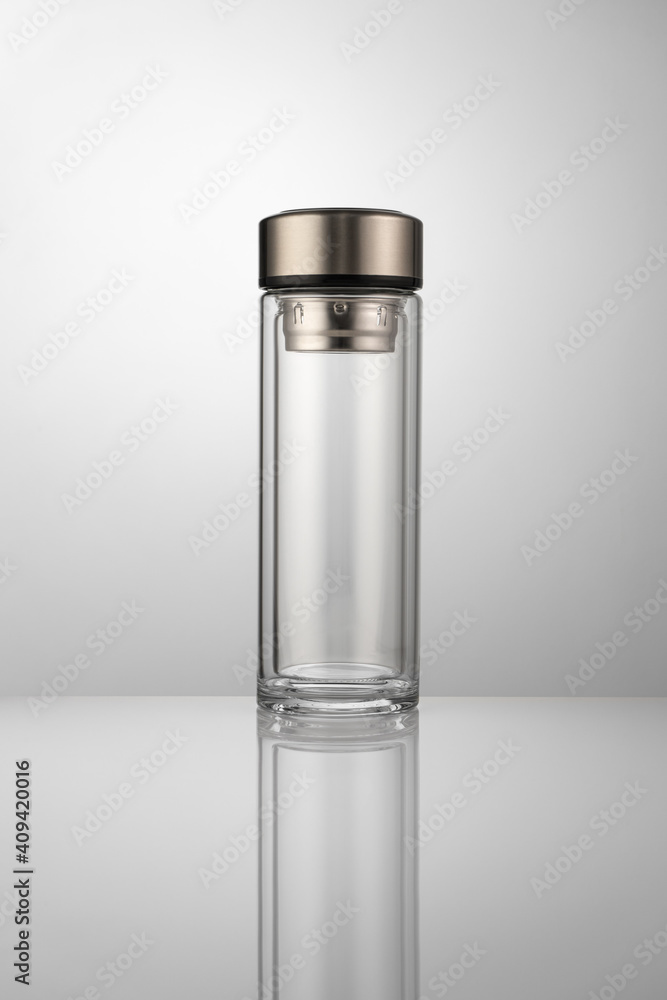 Glass thermos for brewing tea on a white table Glass thermos for brewing tea on a white table