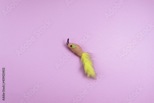 Pet accessory, mouse toy on the violet background. Copy space. 