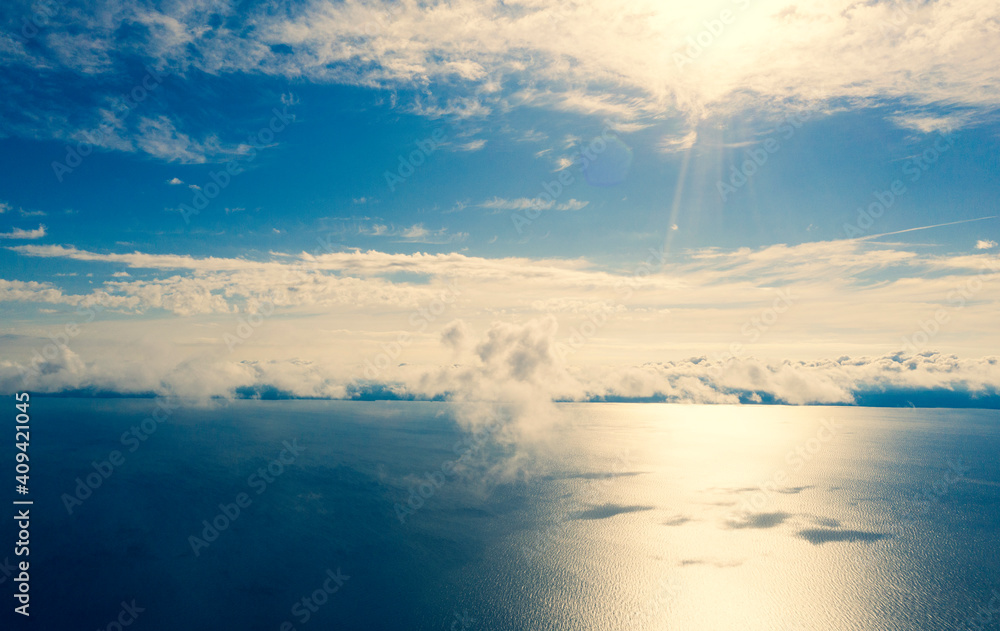 Aerial view small clouds over the sea. View from drone. Aerial top view cloudscape. Texture of clouds. View from above. Sunrise or sunset over clouds. Aerial ocean background