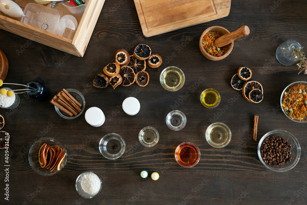 Group of glassware with essential oils, coffee beans, dry fruits and flowers Group of glassware with essential oils, coffee beans, dry fruits and flowers