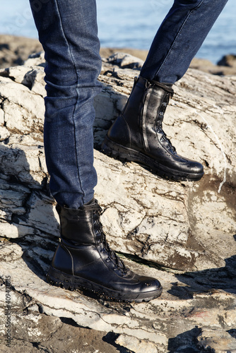 Legs in jeans and black boots on a background in Caucasus