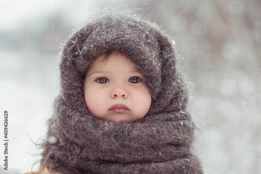 Retro photo of adorable baby in a woolen shawl in winter Retro photo of adorable baby in a woolen shawl in winter