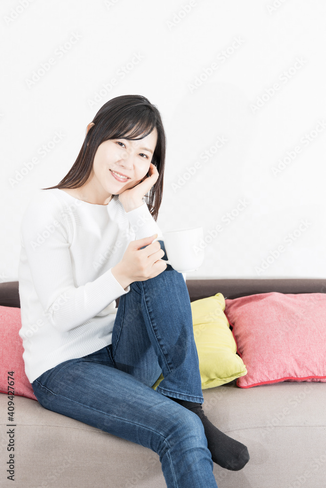 Woman drinking coffee on the couch Woman drinking coffee on the couch