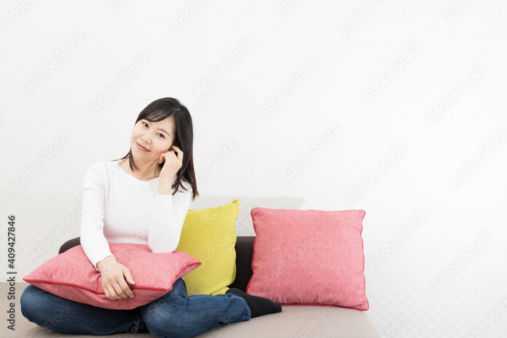 Woman with cushion on the couch