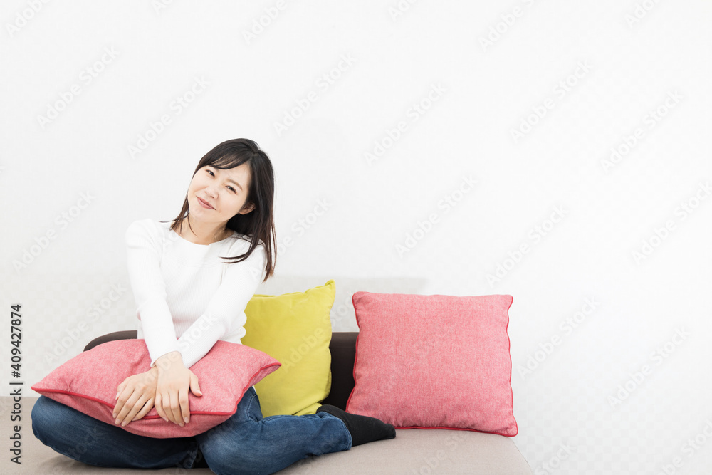 Woman with cushion on the couch Woman with cushion on the couch