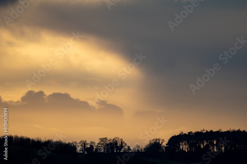 Evening light and dramatic clouds at sunset in winter