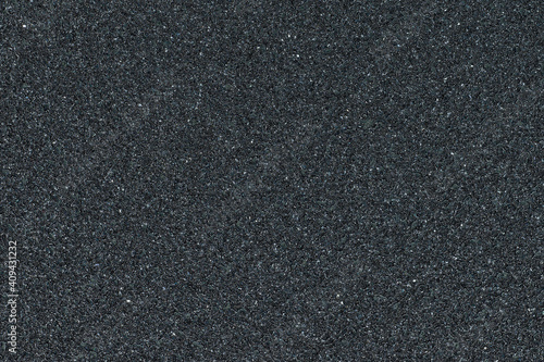 Full frame of black sandpaper texture. Abrasive material with a gritty surface