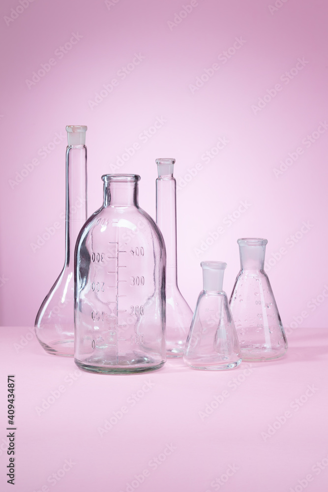 Clean Chemical laboratory glassware on pink background Clean Chemical laboratory glassware on pink background