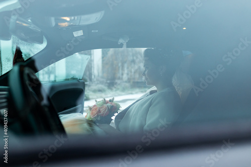 Fototapeta Naklejka Na Ścianę i Meble -  the groom gives his hand to the bride from the car, the politeness and gallantry of people in love, the husband and wife arrived in a decorated car for the wedding
