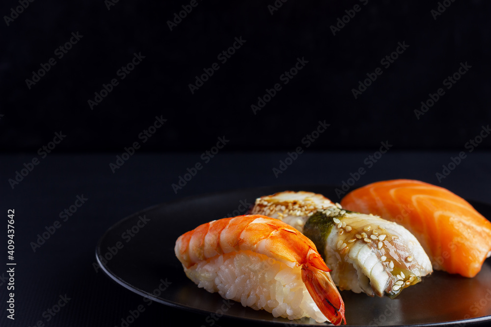 Sushi set on black background, traditional Japanese food. Sushi set on black background, traditional Japanese food.