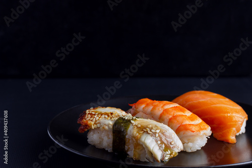 Japanese seafood sushi on black background.