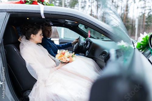 Fototapete the groom gives his hand to the bride from the car, the politeness and gallantry