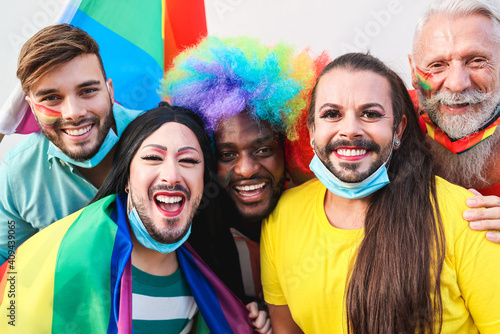 Portrait of multiracial gay people having fun at lgbt pride parade - Focus on front faces photo