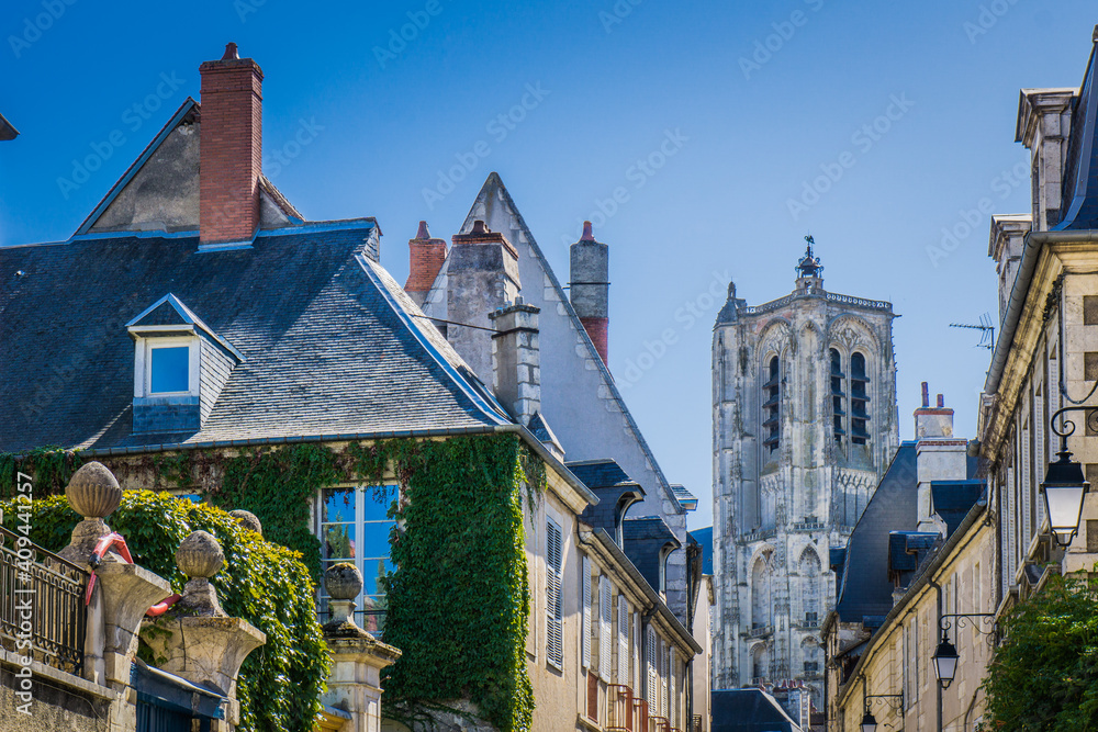 The streets of Bourges (Berry, France) with in the background the tower of St Stephen cathedral, a gothic cathedral on the Unesco World Heritage list.
