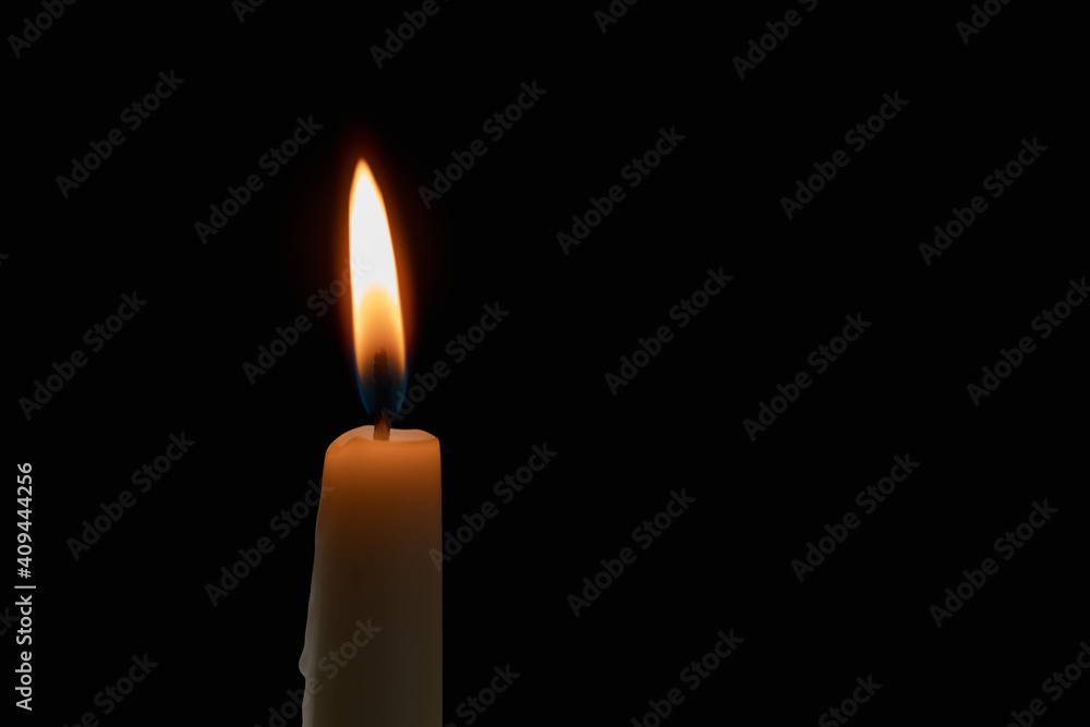 burning candle on black background burning candle on black background