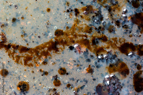 Burned oily leftover grease fat in a pan macro shot air bubbles top view photo