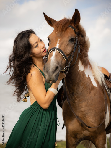 Portrait of woman and brown horse. Asian woman hugging horse. Romantic concept. Love to animals. Nature concept. Bali