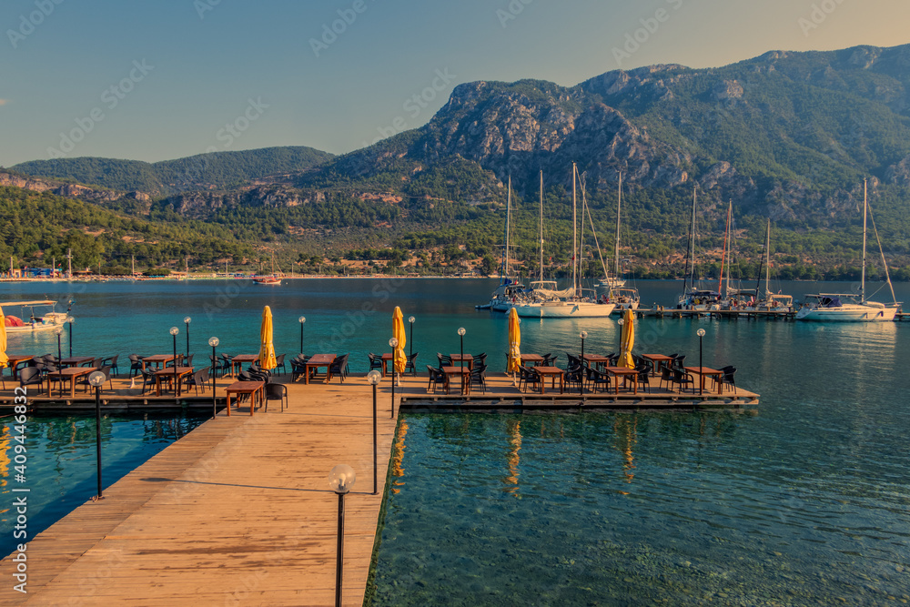 Wooden Pier leading to sailing boats in the bay of Akbuk Limani, Gokova, Turkey