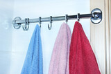 Towels in the bathroom are hanging from the dryer. Bathroom accessories on white background. Hanger in the bathroom.