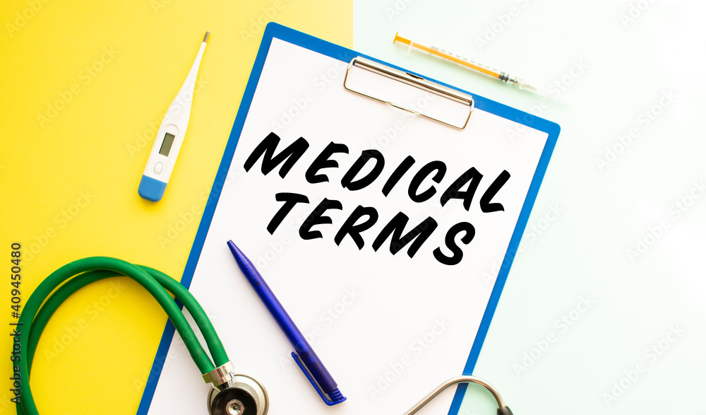 A sheet of paper with text MEDICAL TERMS, stethoscope and medication. A sheet of paper with text MEDICAL TERMS, stethoscope and medication.
