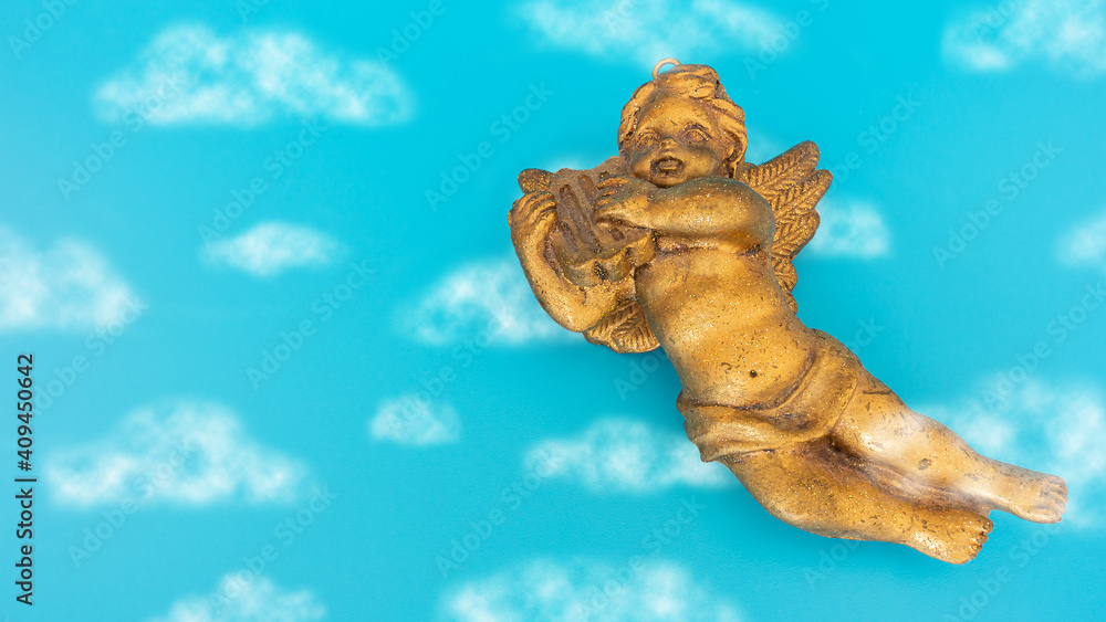 Golden angel with a harp flying in the clouds Golden angel with a harp flying in the clouds