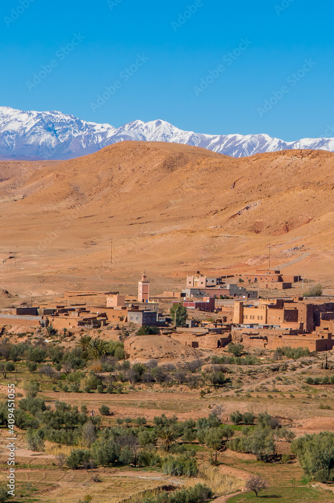 Berber villages near Ait Benhaddou, Morocco with snow-capped mountains of the Atlas in the background