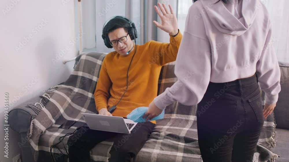 Young couple having an argument. Woman screaming on the man playing games on laptop. High quality 4k footage Young couple having an argument. Woman screaming on the man playing games on laptop. High quality 4k footage