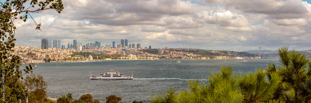 Panoramic View of a ferry crossing the Bosphorus Straits, with a city of Istanbul, Turkey in  the background