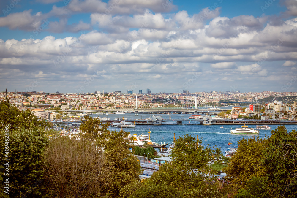 View of  ferries and bridges crossing the Golden Horn of the Bosphorus  with a city of Istanbul, Turkey in  the background