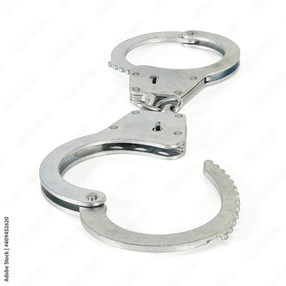 Police handcuffs isolated on white background with light shadows. Pair of real silver handcuff macro close-up high resolution full depth of field. Police handcuffs isolated on white background with light shadows. Pair of real silver handcuff macro close-up high resolution full depth of field.