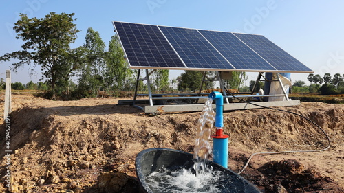 Water pumps and solar panels. Groundwater is pumped with a submersible pump from clean energy or solar energy converted to electric energy on an agricultural farm with a copy area. Selective focus