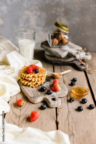 Fresh hommade waffles with fresh fruit and honey topping. photo